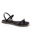 Black Sandals featuring a delicate gold toe ring