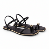 Black Sandals featuring a delicate gold toe ring