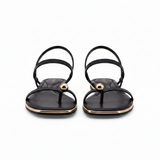 Black Sandals featuring a delicate gold toe ring